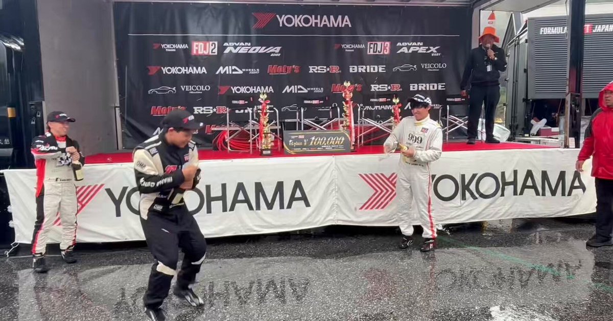 Champagne spray on the wet apron after the FDJ2 2026 Rd.5 podium at Okuibuki Motorpark, Shiga