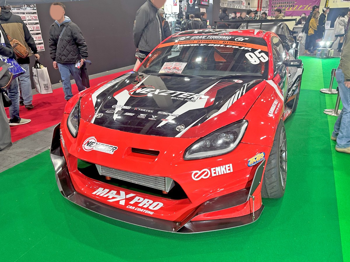 The No.95 Drive to Drift GR86 from the 2025 D1 Grand Prix on a show stand at Osaka Auto Messe 2025