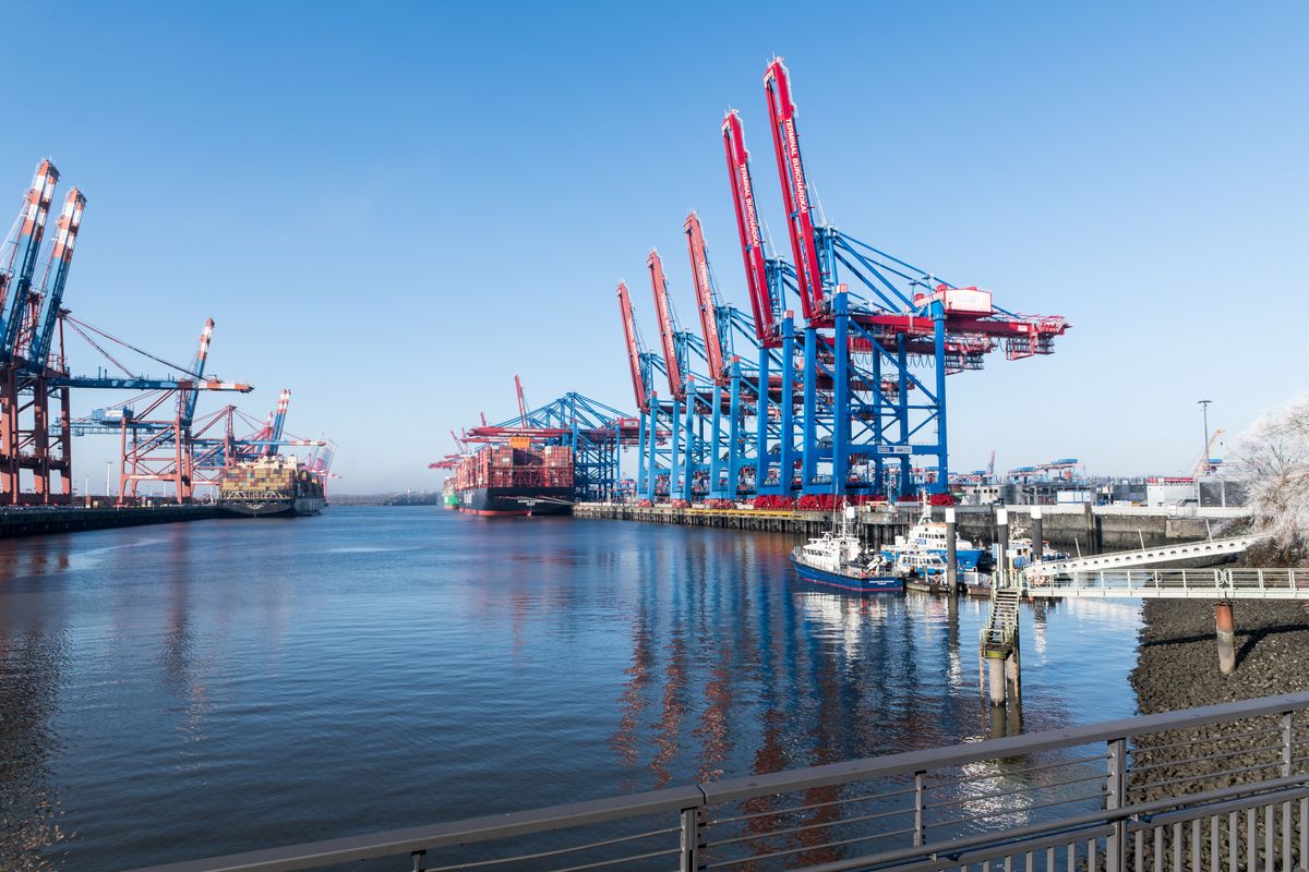 Container gantry cranes and berths at a European port terminal on a clear winter day