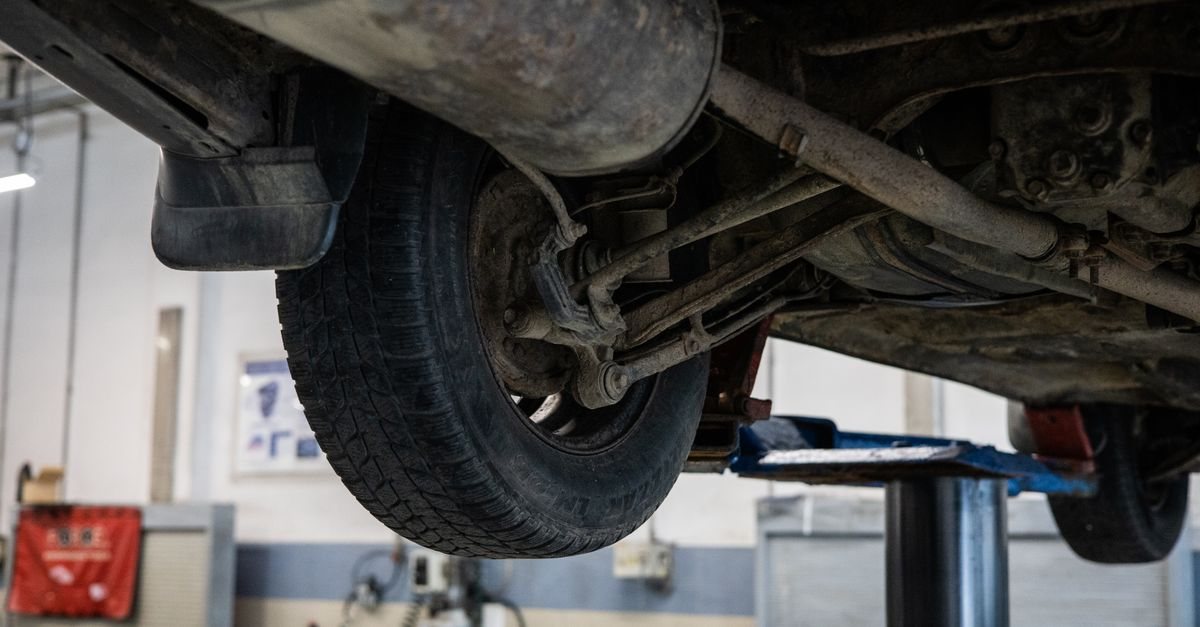 The underside of a car raised on a workshop lift