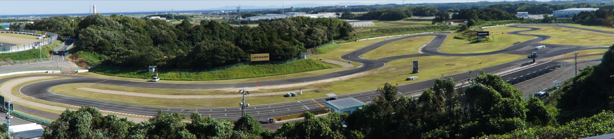 Panorama of the South Course at Suzuka Circuit, an empty 1,264 m tarmac circuit with a pit lane and paddock